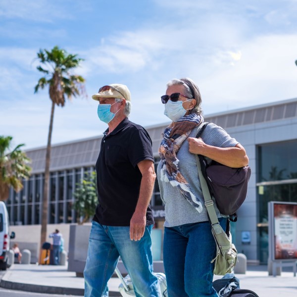 couple at airport wearing face masks