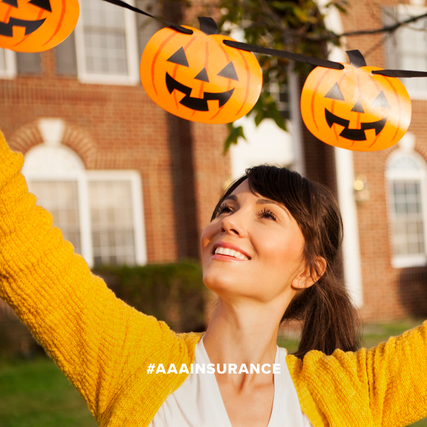 woman hanging halloween decorations