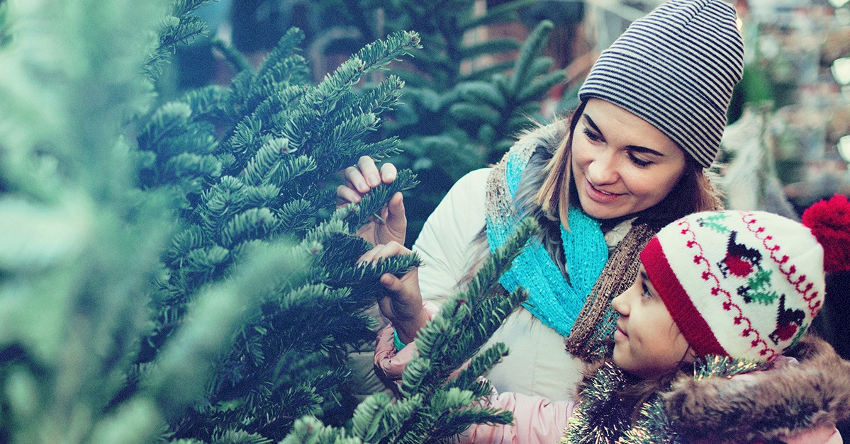 Mother and daughter shopping for christmas tree