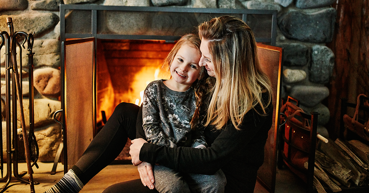 Mother and daughter near fireplace