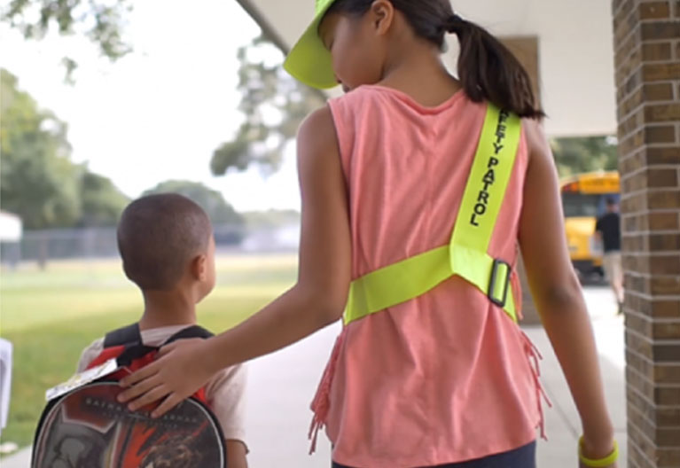 Safety Patroller walking student to class