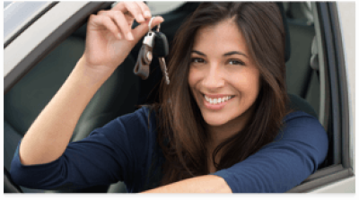 A woman sitting in a car seat holding a set of car keys.