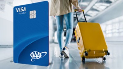 Close up of the AAA Travel Advantage Visa Signature® Credit Card and a woman carrying a suitcase